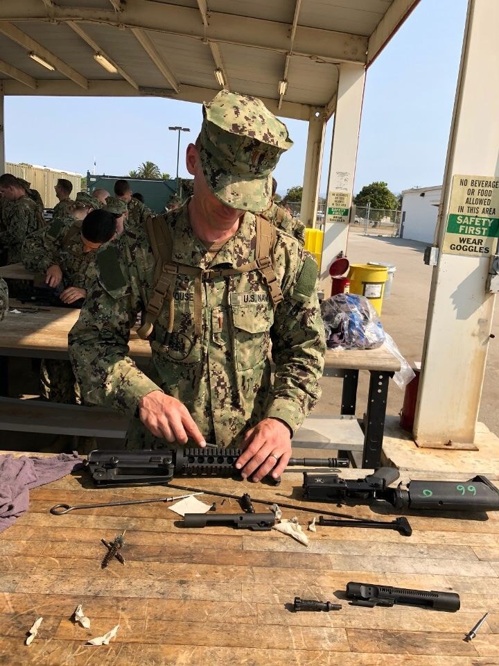 Navy Seabee performing weapons maintenance